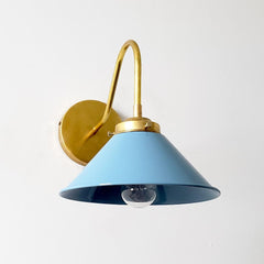 light blue and brass farmhouse modern wall sconce that has a curved brass arm and a light blue cone shade