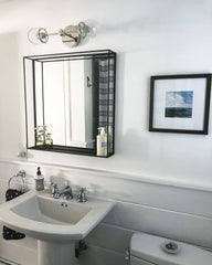 Chrome West End sconce with black square mirror in a bathroom remodel