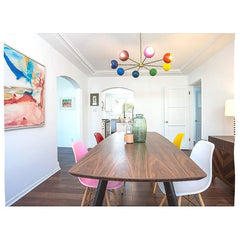 midcentury modern inspired dining room with bright colors and different colored chairs