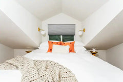 Lighting for a small space - using a sconce above a bed for lighting