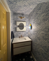 blue white and mustard powderroom with wallpaper, star tile, and a mustard door