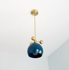 dark turquoise teal and brass modern globe pendant with brass orb ball details midcentury inspired