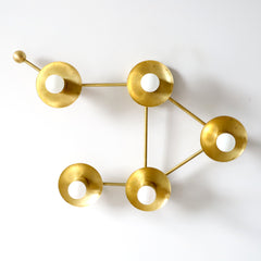 Brass Libra star sign wall sconce or flush-mount ceiling light in an asymmetric shape designed to look like stars