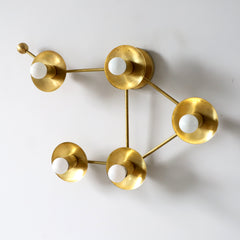 Brass Libra star sign wall sconce or flush-mount ceiling light in an asymmetric shape designed to look like stars - from the other side