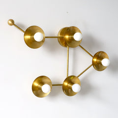 Brass Libra star sign wall sconce or flush-mount ceiling light in an asymmetric shape designed to look like stars - from the side