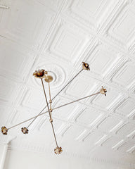 Parisian style ceiling with a large brass and floral chandelier