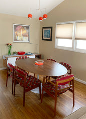 Midcentury modern dining room with accents of poppy red