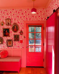 Modern pink wallpapered entryway with a pink pendant light fixture