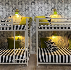 chartreuse and brass loa wall sconce in a black and white room with bunk beds