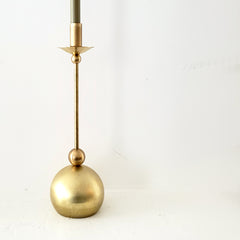 Brass taper candle holder with geometric shapes and a globe base