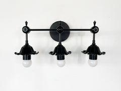 modern black floral three light wall sconce with romanti flowers.  Great black wall sconce for traditional modern or eclectic design bathrooms.  Goes with bright colors and neutrals equally well