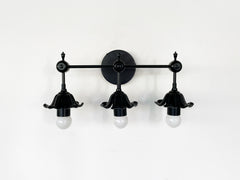 modern black floral three light wall sconce with romanti flowers.  Great black wall sconce for traditional modern or eclectic design bathrooms.  Goes with bright colors and neutrals equally well