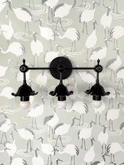 Three light black floral bathroom vanity wall sconce on pale mint and grey crane wallpaper