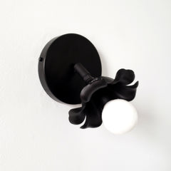 Adjustable victorian modern wall sconce in a black matte finish and floral shape