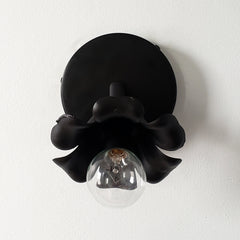 Adjustable victorian modern wall sconce in a black matte finish and floral shape