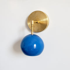 Brass and Blue modern eyeball wall sconce that is midcentury inspired