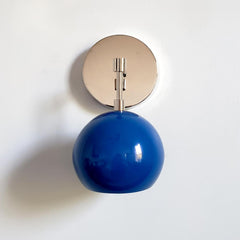 chrome and blue midcentury modern wall sconce with blue shade and chrome hardware