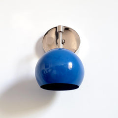 chrome and blue midcentury modern wall sconce with blue shade and chrome hardware