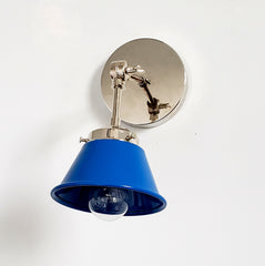 blue and chrome adjustable cone sconce by Sazearc stitches is bright and playful wall lighting for open shelving