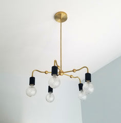 black and brass art deco inspired modern chandelier dining room