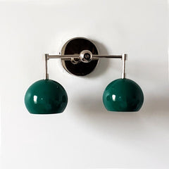 green and chrome two light wall sconce with mid century modern green globe shades