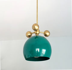 emerald green and brass modern globe pendant with brass orb ball details midcentury inspired
