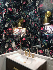 Michoud Sconce in a dark bathroom with floral wallpaper
