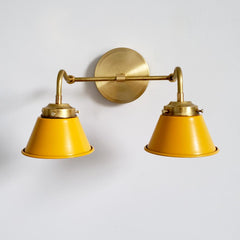 mustard and brass wall sconce for midcentury modern or 60s home decor color palettes.