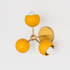 brass and mustard mid century modern wall sconce or flushmount ceiling light made in New Orleans by Sazerac stitches