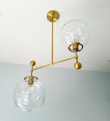 brass and large glass globe two light fixture chandelier mid century style minimalism MCM