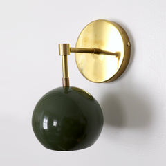 Olive green mid century modern globe wall sconce with brass hardware