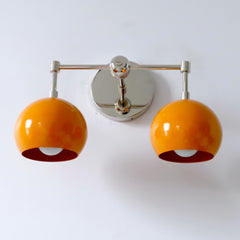 chrome and orange mid century modern two light wall sconce from below