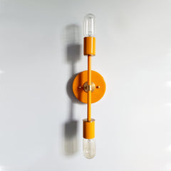 Orange and Brass two modern two light sconce or ceiling light fixture in a bright retro orange color