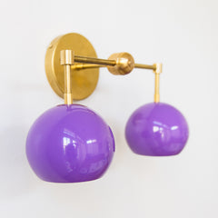 purple and brass two light mid century modern bathroom wall sconce