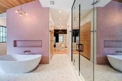 Modern Master Bathroom renovation with brass octavia chandelier above the large white tub