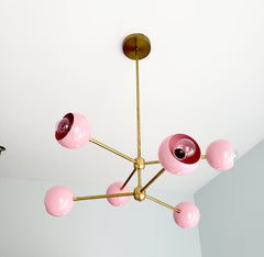 Brass and pink midcentury modern chandelier lighting perfect for nursery or girls room interior design