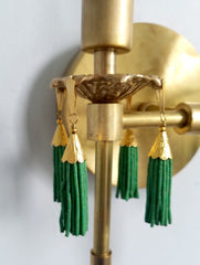 Modern victorian wall lighting sconce features cast gold brass bobeches and green beaded tassels