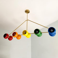Large rainbow and brass chandelier with ROYGBIV colors.  Playroom kids room lighting