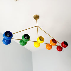 Large rainbow and brass chandelier with ROYGBIV colors.  Playroom kids room lighting