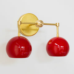 Red and Brass Mid Century Modern two light wall sconce view from side