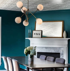 Teal and grey modern dining room with brass chandelier