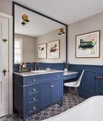 traditional navy bathroom with marble countertops, floral tile flooring, and marble countertops