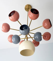 Solaris chandelier with coral grey and cream light shades mid century modern inspired southwestern colors