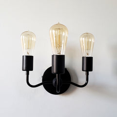 Matte black victorian modern wall sconce. Gothic style light fixture that has modern edge