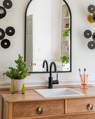 Black and brass eclectic wall sconces for a bathroom renovation