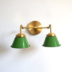Spring Green and Brass Double Kelly Sconce features colorful shades and a raw brass finish modern bathroom lighting