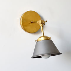 Steel and brass farmhouse modern adjustable wall sconce that is perfect for kitchen and bathroom renovations