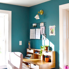 Teal Office Corner with a white and brass wall sconce