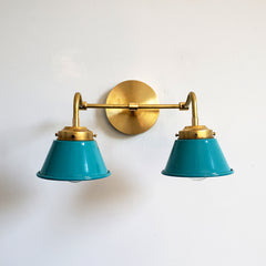 Teal and Brass Double Kelly Sconce features colorful shades and a raw brass finish modern bathroom lighting