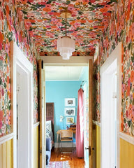 Colorful Hallway with Rainbow Floral Wallpaper on the walls and ceiling with yellow trim